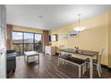 Cozy living room with balcony access, dining area, and wood-look floors at 210 75Th Ave N # 4032, Myrtle Beach, SC 29572