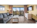 Comfortable living room featuring a sofa, dresser, and balcony access at 210 75Th Ave N # 4032, Myrtle Beach, SC 29572