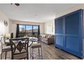 Living and dining area boasting floor-to-ceiling windows, comfortable seating, and stylish decor with calming, neutral colors at 210 75Th Ave N # 4033, Myrtle Beach, SC 29572