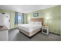 Comfortable bedroom with a king-size bed, stylish lamps, and a tranquil view from the window at 2301 S Ocean Blvd. # 825, Myrtle Beach, SC 29577