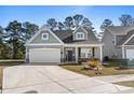 Charming one-story home featuring a two-car garage and a welcoming front porch at 2449 Campton Loop, Conway, SC 29527