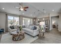 Comfortable living room featuring hardwood floors, a ceiling fan, and a sectional sofa with accent pillows at 2501 Brescia St., Myrtle Beach, SC 29579