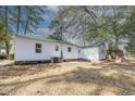 The backyard features a green roof, white siding, mature trees, and outdoor space at 2505 Redwood St., Georgetown, SC 29440