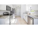 Modern kitchen features white cabinets, stainless steel appliances, and stone countertops at 260 Barclay Dr., Myrtle Beach, SC 29579