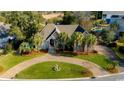 An elevated view of the beautiful home with a circular brick driveway, mature landscaping, and well maintained lawn at 2803 Ships Wheel Dr., North Myrtle Beach, SC 29582