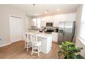 Modern kitchen with white cabinets, granite countertops, stainless steel appliances, and center island with seating at 3491 Alexandria Ave., Myrtle Beach, SC 29577