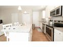 Bright kitchen with stainless steel appliances, granite countertops, and white cabinets at 3491 Alexandria Ave., Myrtle Beach, SC 29577