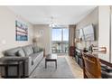 Cozy living room with comfortable sofa, large windows, balcony access, and serene ocean views at 3601 N Ocean Blvd. # 1840, North Myrtle Beach, SC 29582