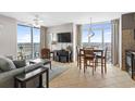 Bright living room with tile flooring, a grey sofa, and access to a balcony offering beautiful ocean views at 3601 N Ocean Blvd. # 1840, North Myrtle Beach, SC 29582
