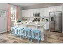 Bright, open kitchen featuring a granite island with seating and stainless steel refrigerator at 413 Falling Leaf Loop, Myrtle Beach, SC 29588