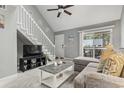 Inviting living room with a ceiling fan, staircase, sliding glass doors, and comfortable seating at 416 Cambridge Circle # H5, Murrells Inlet, SC 29576
