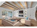Bright living room with wood beams, fireplace, hardwood floors, modern light fixture and ample seating at 4340 Parkland Dr., Myrtle Beach, SC 29579