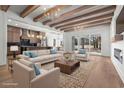 Bright living room with wood beams, fireplace, hardwood floors, modern light fixture and ample seating at 4340 Parkland Dr., Myrtle Beach, SC 29579