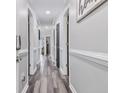Hallway featuring wood-style floors, doors and trim painted in neutral colors, and modern lighting fixtures at 4506 W Harbour Ct. # U2, Little River, SC 29566