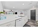 Open kitchen featuring a modern sink, white cabinets, and a pass-through to the living area at 4506 W Harbour Ct. # U2, Little River, SC 29566