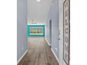 Inviting entryway with light gray walls, wood flooring, and an open view into the bright, spacious living area at 5215 Southern Trail, Myrtle Beach, SC 29579