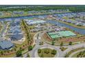 Stunning aerial view of community amenities featuring a pool, tennis courts, and waterfront access at 6614 Torino Lane, Myrtle Beach, SC 29572
