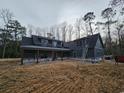 New construction home with gray siding, covered porch, ladder, and construction materials in the yard at 8012 Old Reaves Ferry Rd., Conway, SC 29526