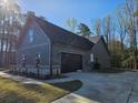 Side view of a craftsman-style home features a 2 car garage and attractive stone accents at 8012 Old Reaves Ferry Rd., Conway, SC 29526