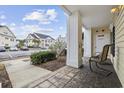 View from condo porch with seating; features building and ample parking at 805 Sunswept Ct. # 102, Murrells Inlet, SC 29576
