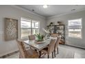 Bright dining room featuring a stylish table, elegant chairs, and views of the surrounding landscape at 914 Agostino Dr., Myrtle Beach, SC 29579