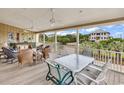 Relaxing outdoor porch area with comfortable seating, ceiling fans, and treetop views at 994 Debordieu Blvd., Georgetown, SC 29440