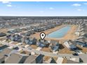 An aerial view displays a neighborhood with a central pond near this home at 1047 Harbison Circle, Myrtle Beach, SC 29579