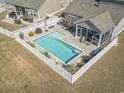 Aerial shot of a fenced backyard featuring a private pool and screened patio at 1047 Harbison Circle, Myrtle Beach, SC 29579