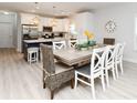 Open floor plan dining room featuring a large table with seating for eight and stylish decor at 114-B 7Th Ave. N, Surfside Beach, SC 29575
