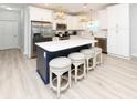 Modern kitchen with white cabinets, stainless appliances, a large island and stylish pendant lighting at 114-B 7Th Ave. N, Surfside Beach, SC 29575
