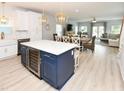 Open-concept kitchen island with wine cooler overlooking the dining and living areas with ample seating at 114-B 7Th Ave. N, Surfside Beach, SC 29575