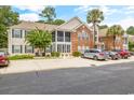 The exterior showcases a blend of brick and siding, set against a backdrop of lush greenery at 120 Brentwood Dr. # E, Murrells Inlet, SC 29576