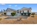 Well-maintained single-story home featuring a welcoming front porch and manicured landscaping at 1220 Dunraven Ct., Conway, SC 29527