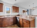 Traditional kitchen with brown cabinets, solid surface countertops and views to dining area at 1220 Dunraven Ct., Conway, SC 29527