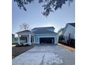 Rear exterior view of house with blue siding, an attached garage, and a covered side porch at 1517 James Island Ave., North Myrtle Beach, SC 29582