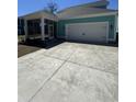 Exterior shot showing the screened in porch, garage and large concrete driveway at 1517 James Island Ave., North Myrtle Beach, SC 29582
