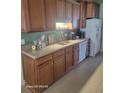 Well-lit kitchen featuring wood cabinets, modern appliances, and tile flooring at 153 Highmeadow Ln., Aynor, SC 29511