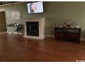 Living room featuring a fireplace and a decorative console table at 153 Highmeadow Ln., Aynor, SC 29511