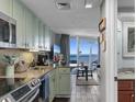 Modern kitchen with granite countertops, stainless steel appliances and an ocean view at 158 Seawatch Dr. # 905, Myrtle Beach, SC 29572