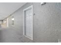 Exterior view of condo unit 1101's front door along a gray walled hallway with a concrete floor at 161 Seawatch Dr. # 1101, Myrtle Beach, SC 29572
