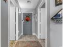 Hallway view with decor leading to a grey door and entrance with an area rug and light wood floors at 161 Seawatch Dr. # 1101, Myrtle Beach, SC 29572