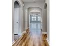 Hallway with beautiful arched doorways, modern lighting, leading into an open-concept living space at 177 Azure Loop, Myrtle Beach, SC 29588