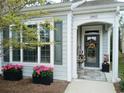 Close-up of a charming front entrance with a decorative wreath and flower planters at 1883 Suncrest Dr., Myrtle Beach, SC 29577
