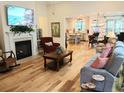 Bright, open-concept living room featuring a fireplace and seamless flow to the kitchen at 1883 Suncrest Dr., Myrtle Beach, SC 29577