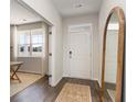Bright entryway with wood-look floors, a large mirror, and view of a naturally lit room at 210 Bald Cypress Way, Conway, SC 29527