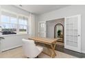 Inviting home office with a neutral palette, large window, and double doors at 210 Bald Cypress Way, Conway, SC 29527