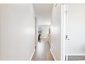 Bright hallway with hardwood floors, leading into a sunlit living and dining area at 2106 Ainsley Dr., Little River, SC 29566