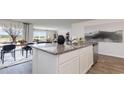 Modern kitchen island with granite countertops, stainless steel appliances, and open layout to living area at 214 Bald Cypress Way, Conway, SC 29527