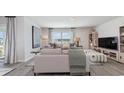 Bright living room featuring neutral tones, stylish furniture, and large windows at 214 Bald Cypress Way, Conway, SC 29527