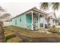Charming single story turquoise home with a cozy covered front porch at 230 Addison Cottage Way, Murrells Inlet, SC 29576